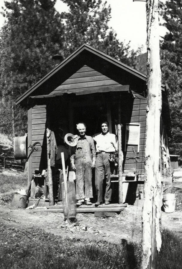 Two men standing in the doorway of Tobs cabin near Wallace, Idaho.