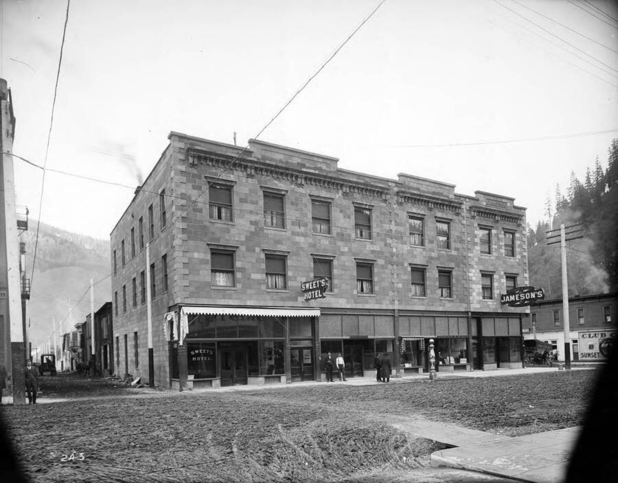 Outside view of Sweet's Hotel and Jameson's Hotel. Morley Barber Shop and Pfister Tailors occupy the lower section on right.
