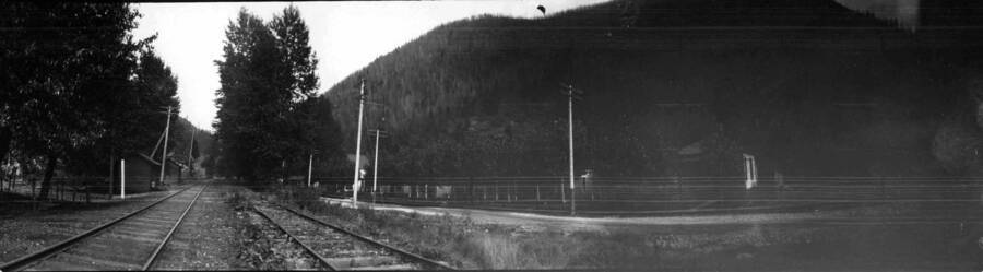 View of railroad tracks and houses. Panoramic photograph of Wallace, Idaho.