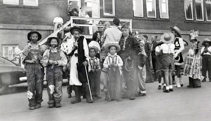 A group of young boys in costumes posing together during the 49'er Parade in Mullan, Idaho.