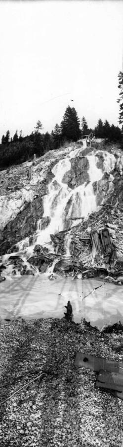 Water flowing down a hill side after being plumbed out of the mine. Panoramic photograph of Wallace, Idaho.