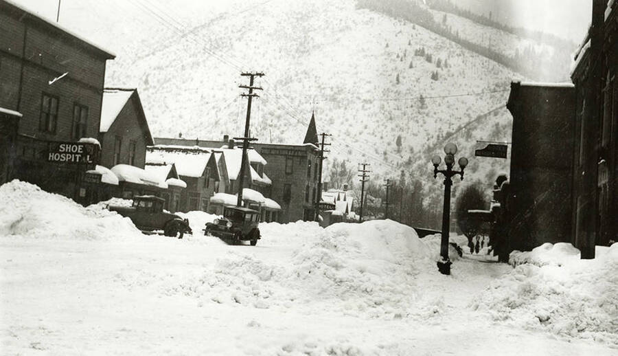 A west-facing view of Cedar Street in Wallace, Idaho, covered in snow.