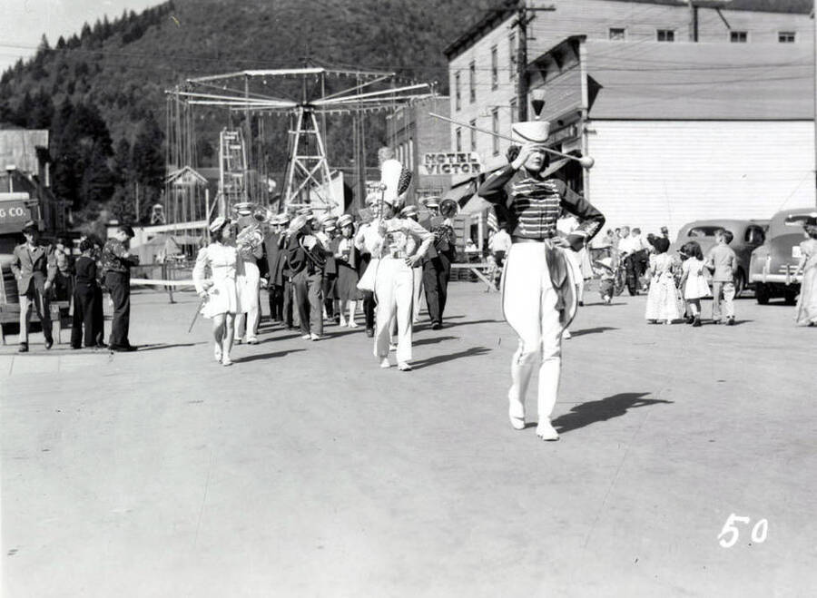 Baton twirlers leading a marching band down the street during the 49'er Parade in Mullan, Idaho.