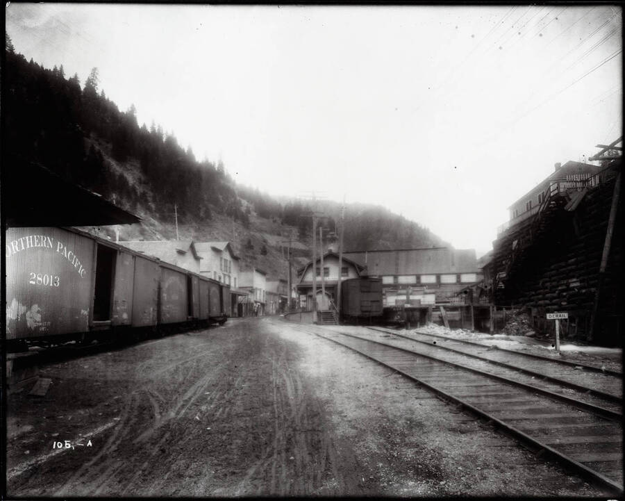 Image looking into Burke, Idaho, a Northern Pacific railcar 28031 is pictured on the right.