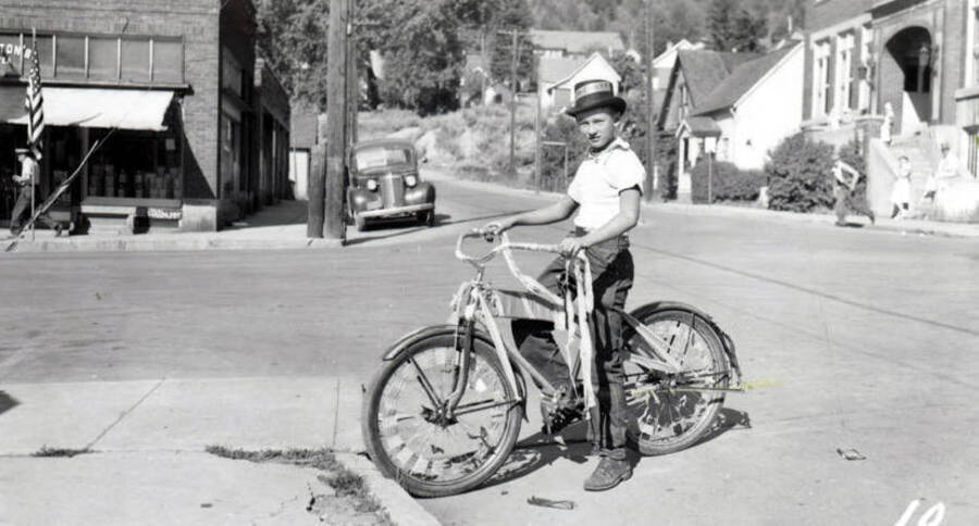 A child in costume on a bike decorated with streamers during the 49'er Parade in Mullan, Idaho.