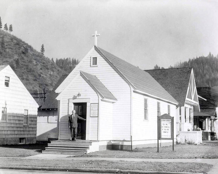 Rev. Martin A. Russert and his wife walking into the Bethany Lutheran Church and parsonage in Wallace, Idaho.