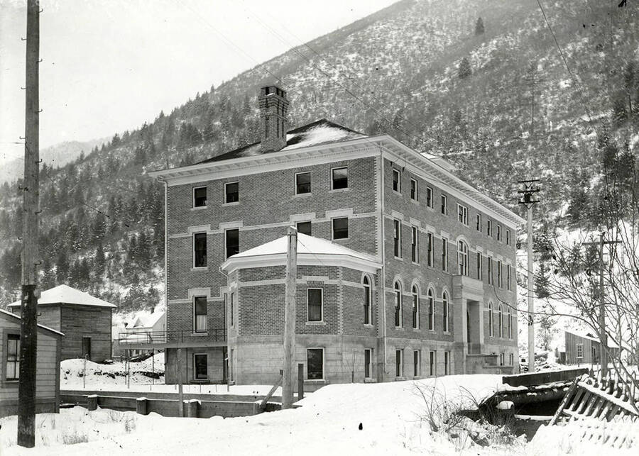 Exterior view of the Our Lady of Lourdes Academy in Wallace, Idaho covered in snow.
