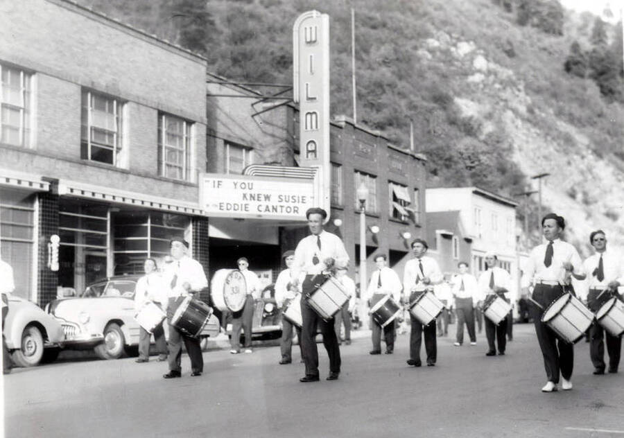 A drum band moving down the street during the Elks Round Up Parade.