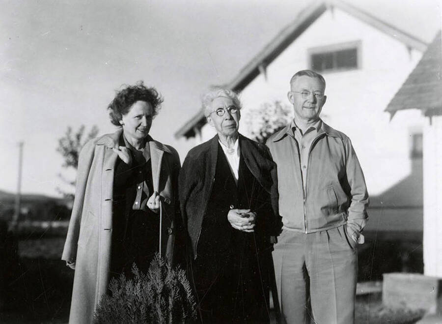 Nellie Stockbridge (1868-1965), center, standing with her family on her farm near Wallace, Idaho.