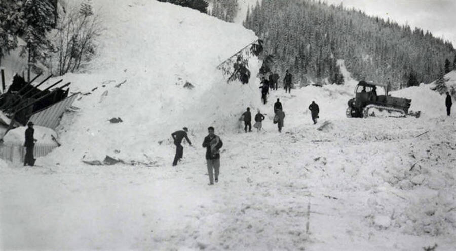 People standing atop the snow slide in historical Yellow Dog, Idaho.