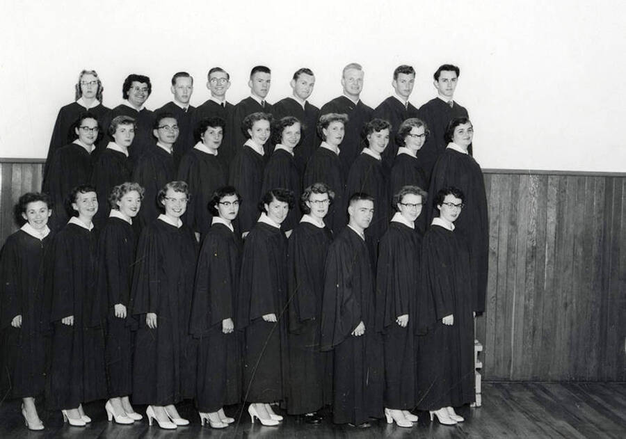 Group photo of the graduating class at Wallace High School in Wallace, Idaho. Back row (left to right): Aljean Wickberg, Violet Ban, Richard Christopherson, Ralph Pribble, Ken Truesdell, Jim Curtis, Bill Jacobson, Bill Lindroos, Terry Murphy. Middle row (left to right): Ruby Raber, Kay Tiffney, Terry Storjohann, Betty Bentham, Christy Terrill, Sara Ann Cooke, Dolores Erickson, Wanda Wolfgram, Mimi Deshler, Lillian Helgeson. Front row (left to right): Barbara Riegel, Gerry Drinnon, Mary Anna Trickey, Carol Anderson, Cecelia Montoya, Aharlotte Carlson, Maureen Allen, Don Hogan, Milli Grant, Bette Jane Olson.