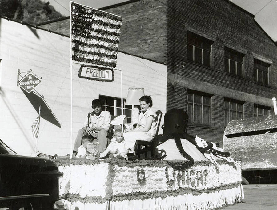 A float featuring an octopus holding a sign reading "Czechoslovakia" and threatening an American family seated under a sign reading "freedom" during the Elks Parade in Wallace, Idaho. Along the side of the float is written "Which?"