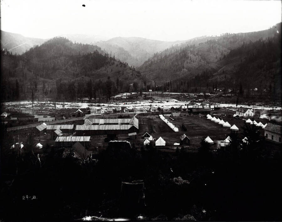 A distant view of the Bull Pen in Kellogg, Idaho; Tents and wooden buildings are pictured.