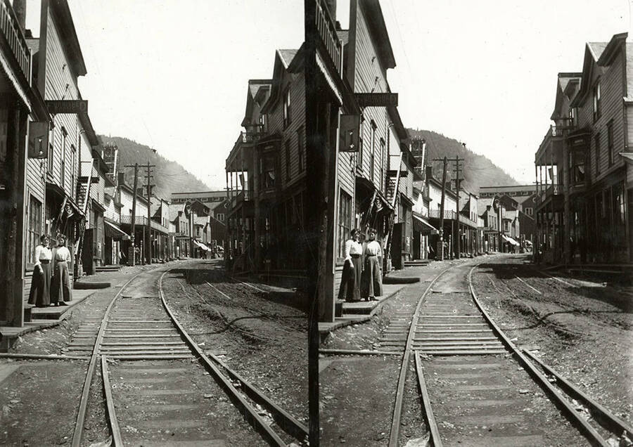 Stereoscopic view of the railroad tracks in Burke, Idaho. The tracks run through the center of town.