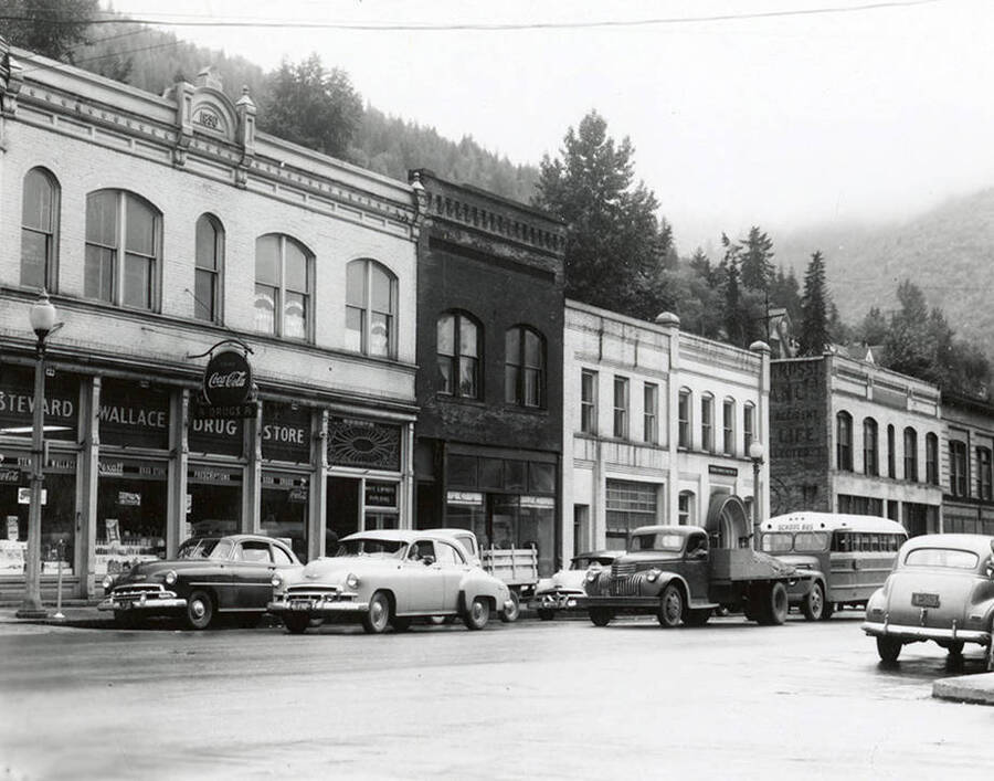 View of the Old Elks Temple in Wallace, Idaho. Cars can be seen driving in front of the building.