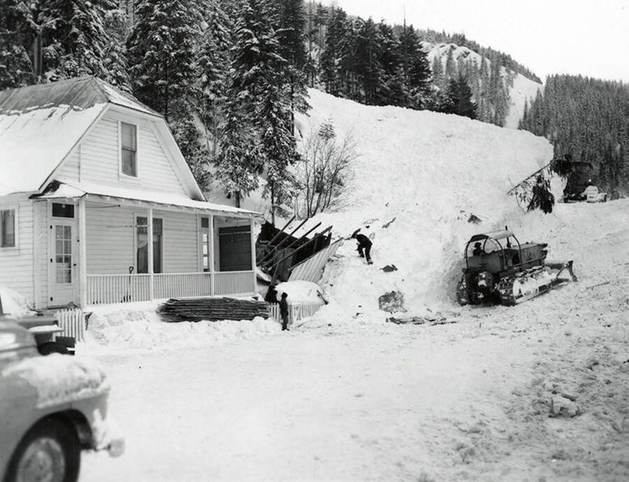 View of the snow slide in historical Yellow Dog, Idaho (near modern-day Potlatch, Idaho). People can be seen standing in the snow.