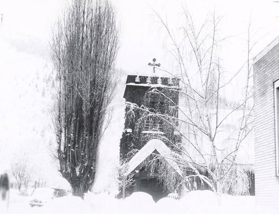 Holy Trinity Episcopal Church in Wallace, Idaho, covered in snow.