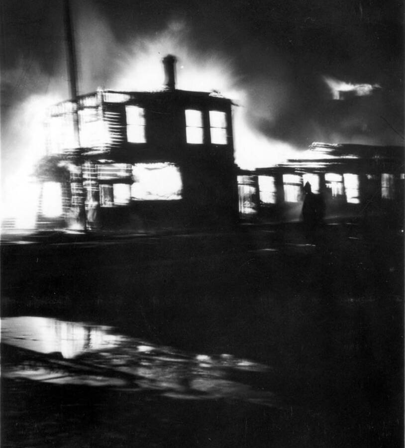 Night time image of the fire burning buildings in Wallace, Idaho. Forest fire 1910.