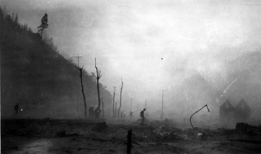 Image shows people assessing the damage left by the fire in Wallace, Idaho. Forest fire 1910.