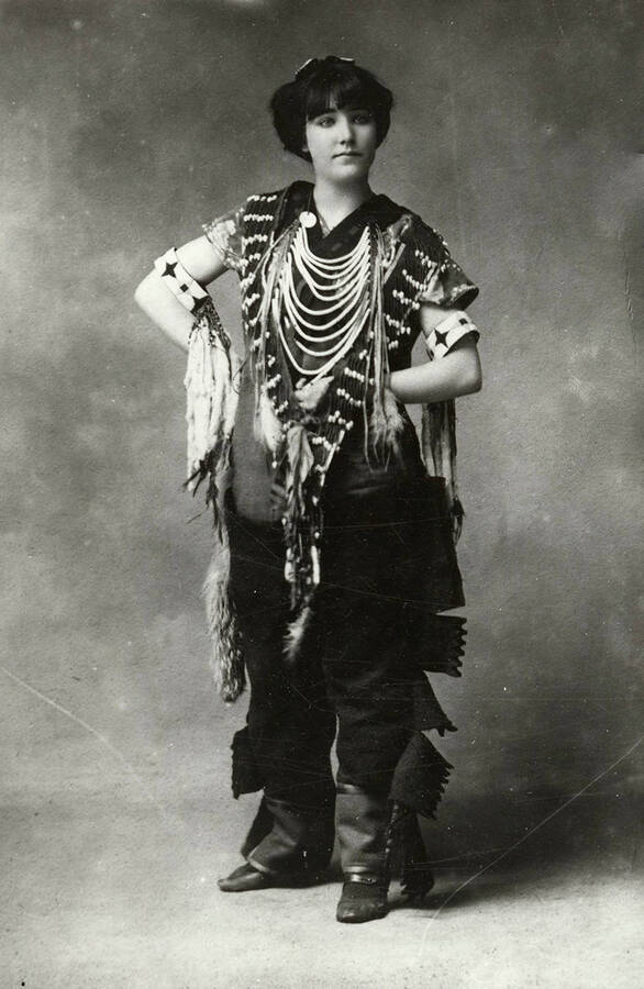 Portrait of a woman wearing Native American clothing.