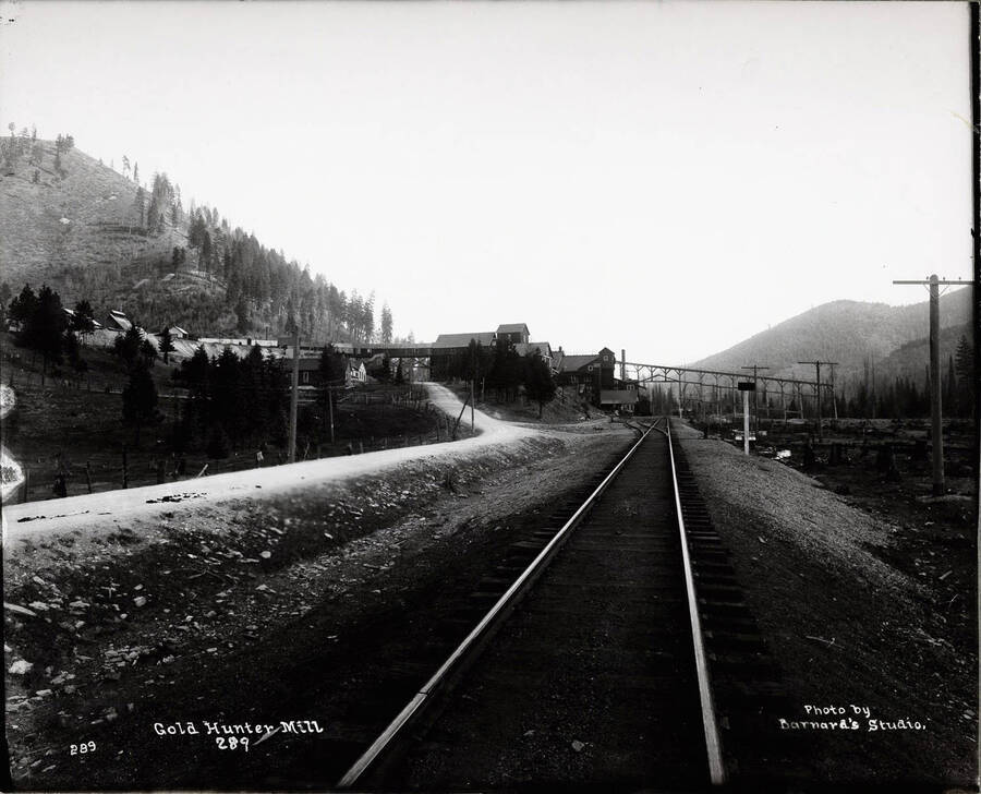 Distant view looking down railroad tracks at Gold Hunter Mill outside Mullan, Idaho.