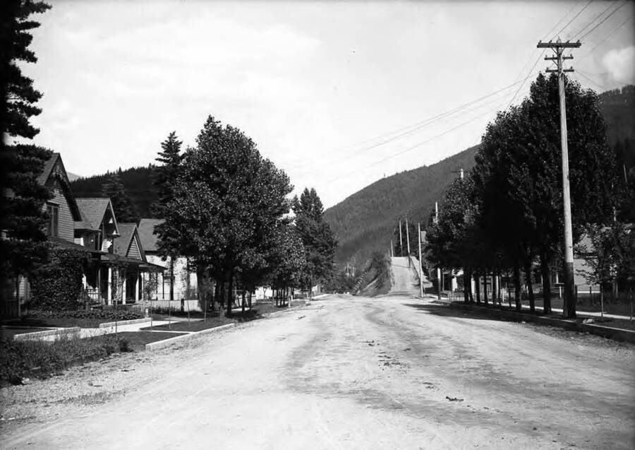 Image shows a residential area; Bank St. looking East from 1st in Wallace, Idaho.