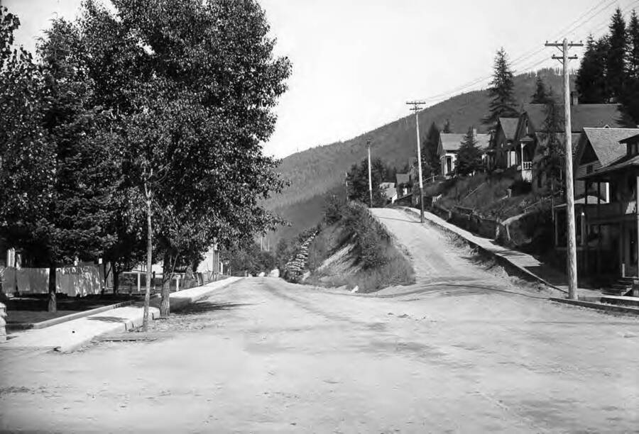 Image shows a residential area; Bank St. looking East from 29th in Wallace, Idaho.