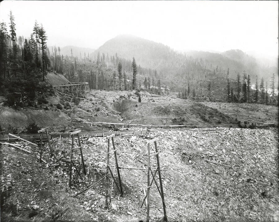 North side, Coeur d'Alene Mining District (Murray area).  Rail supports are visible in the foreground of the photograph, while still standing tracks are visible on Barr's in the background.
