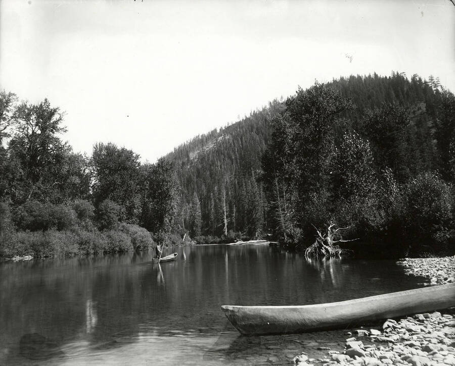 View of a man on a canoe at the big pool near the North Fork at Coeur d'Alene Mining District.