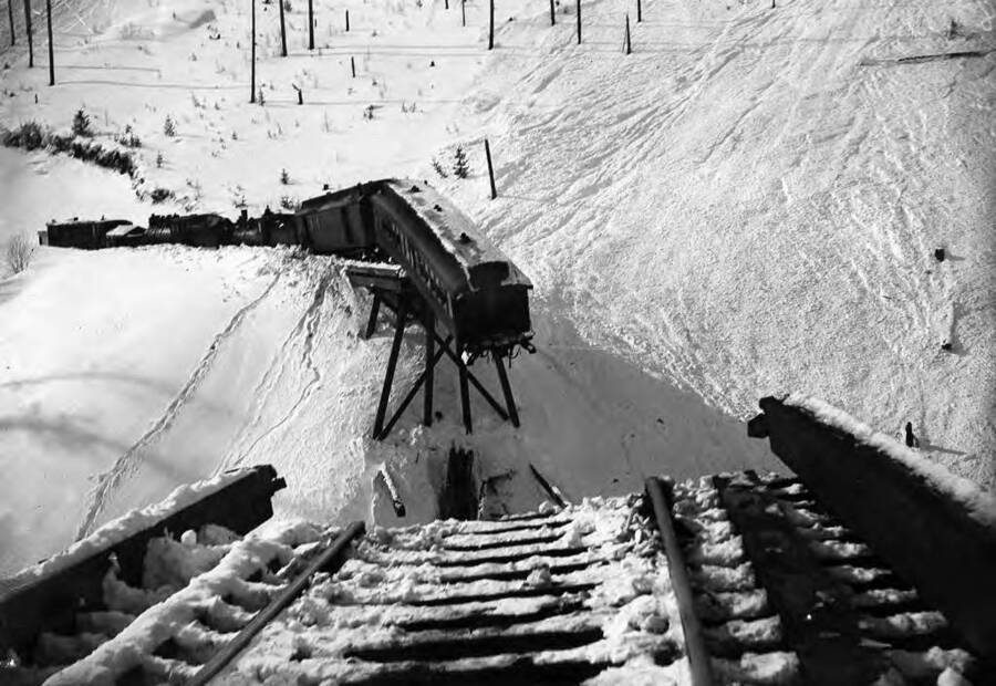 Image shows a train wreck on S Bridge, 1903, above Mullan, Idaho.