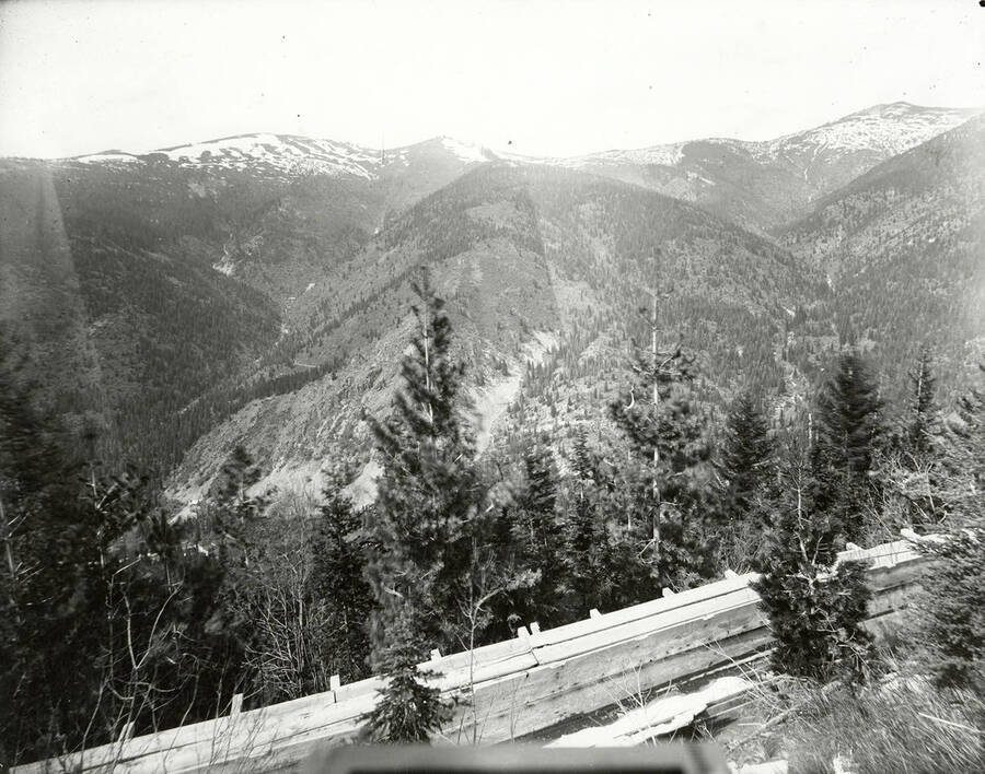 View of a mining flume surrounded by mountains.