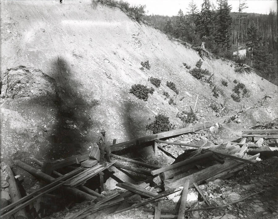 North side, Coeur d'Alene Mining District (Murray area). One large flume can be seen in the background.