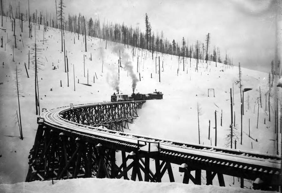 Image of a snow view of a bridge, with a rotary snow plow on the S bridge, 1890, Idaho.