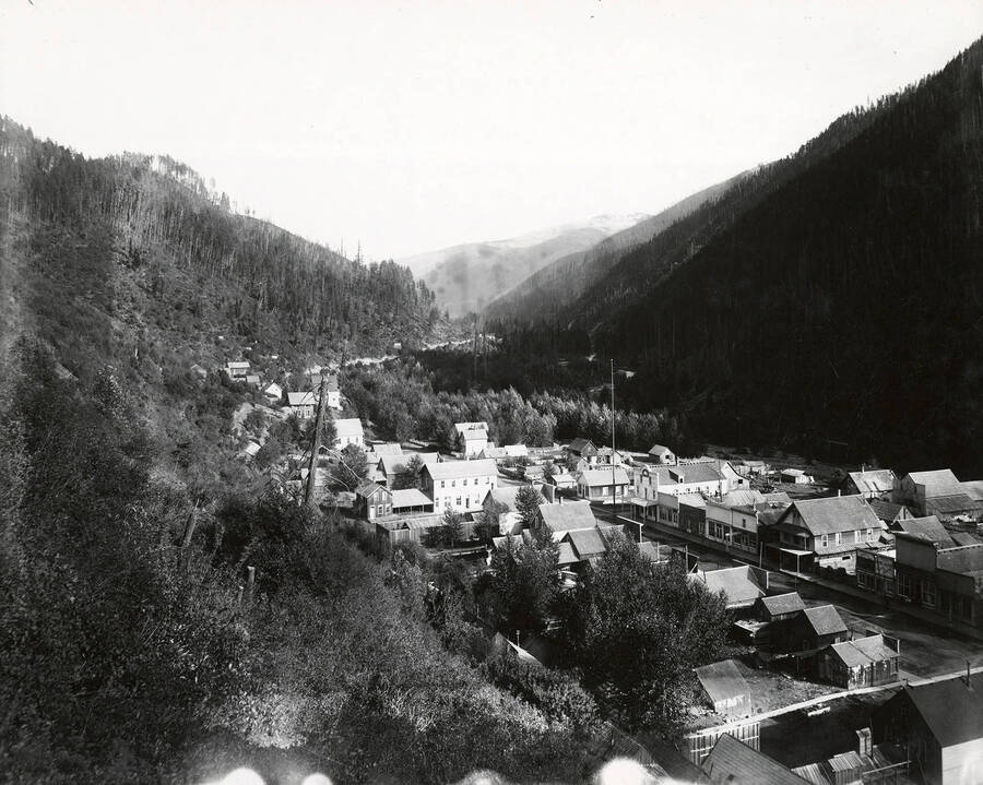 View of the Widow, Last, Chance, Coony Wood, Butte, and other placers. This is located on the north side of the Coeur d'Alene Mining District, in the Murray area. The town of Murray can be seen.