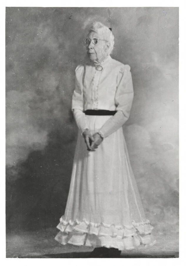 A formal portrait of Nellie Stockbridge, taken at the North Idaho Press Jubilee. Ms. Stockbridge is wearing an early 1900's dress.