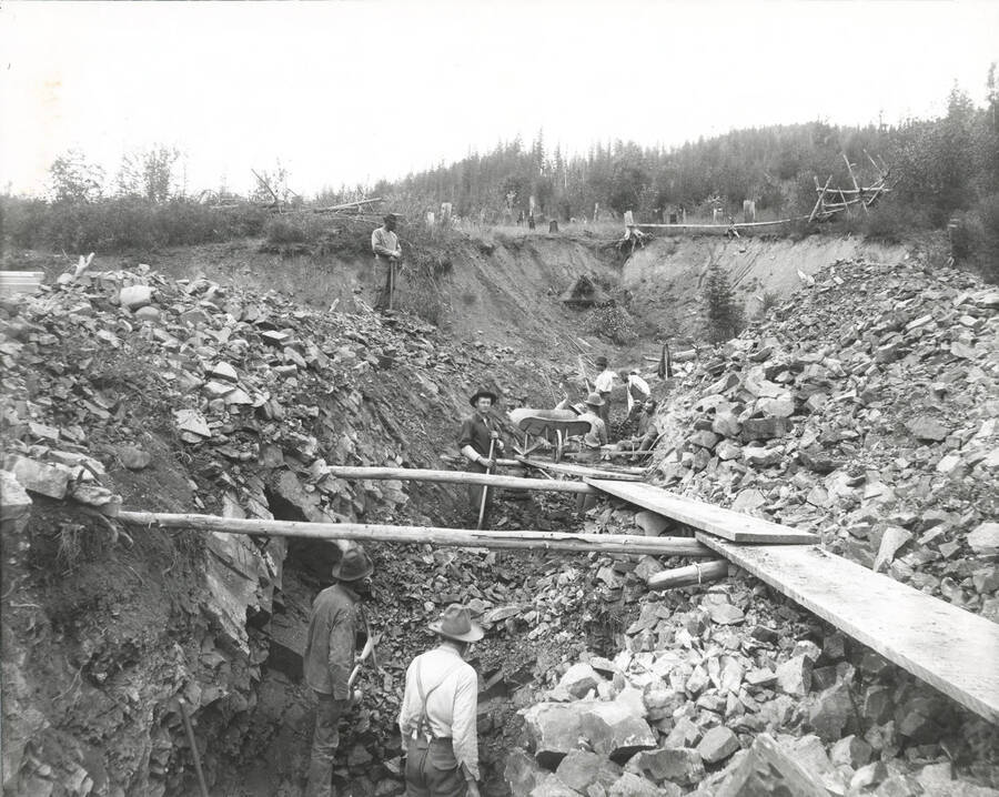 North side, Coeur d'Alene Mining District (Murray area). In this photograph, workers are preparing bed rock for placer mining.