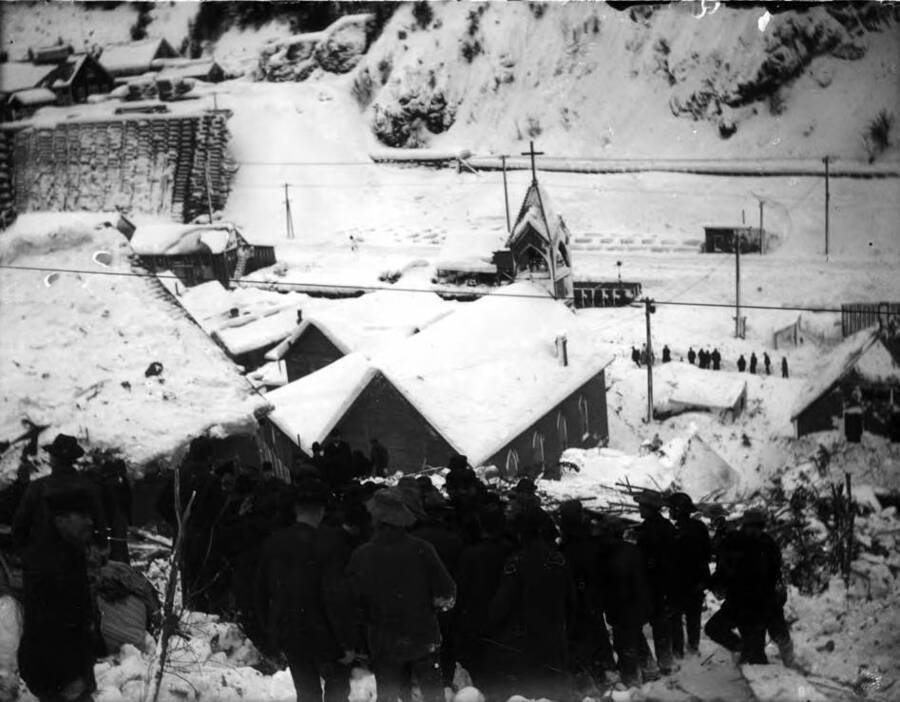 Image shows men assessing damage from a snowslide in Mace, Idaho, 1910.