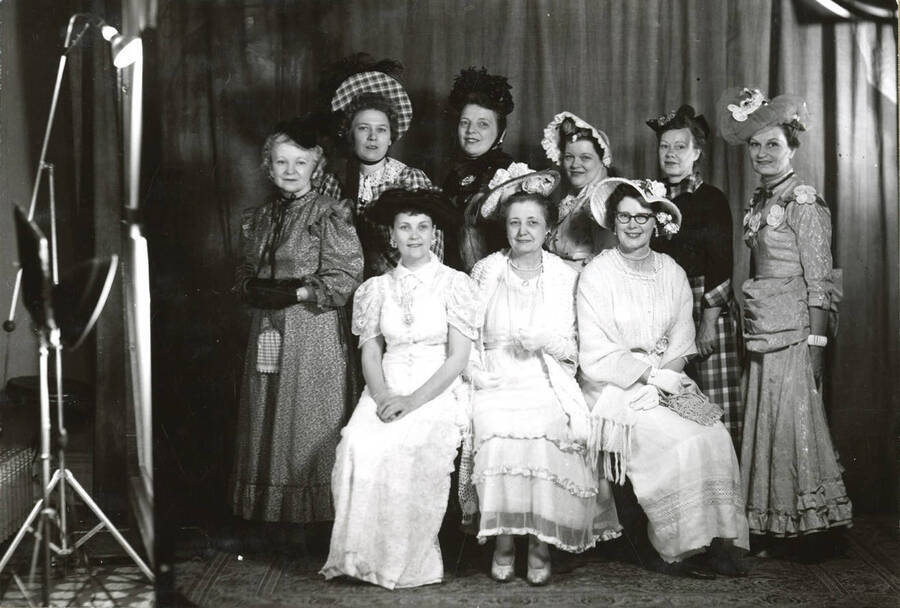 Formal portrait of a group of ladies in fashion dresses at the North Idaho Press Jubilee.