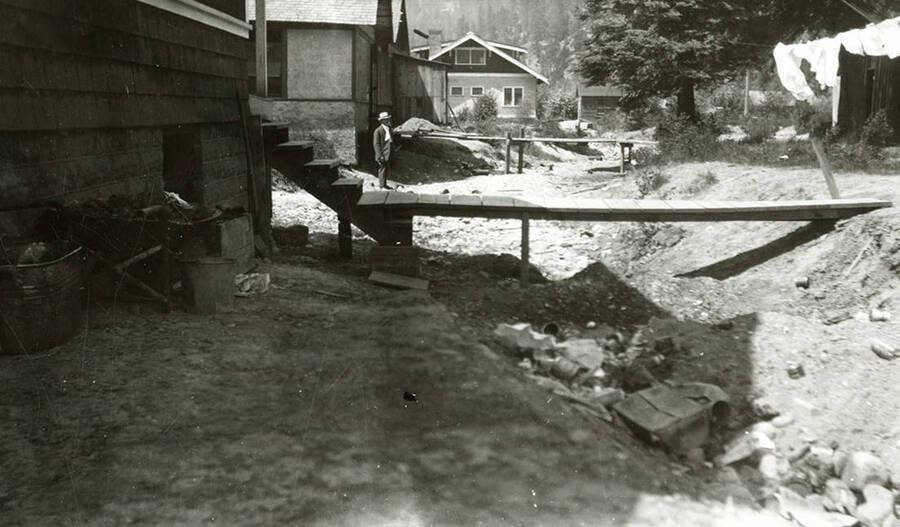 The Sunnyside Addition in Kellogg, Idaho during the flood of 1933. A person can be seen standing in between the houses.