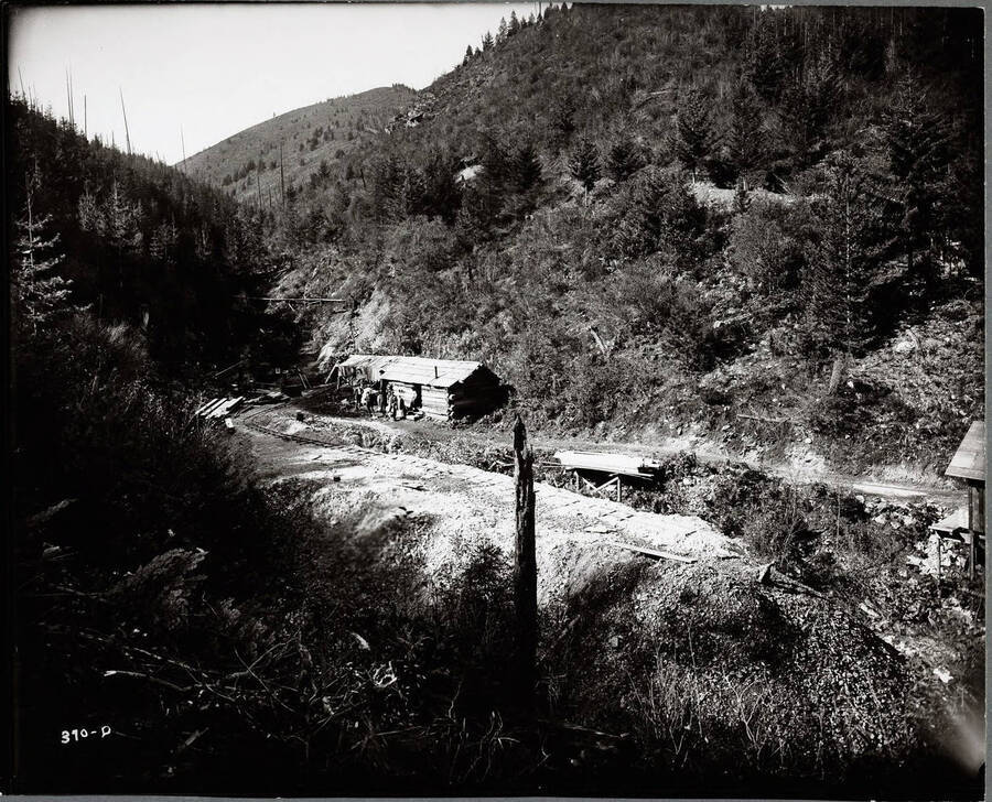 Log cabin next to railroad tracks