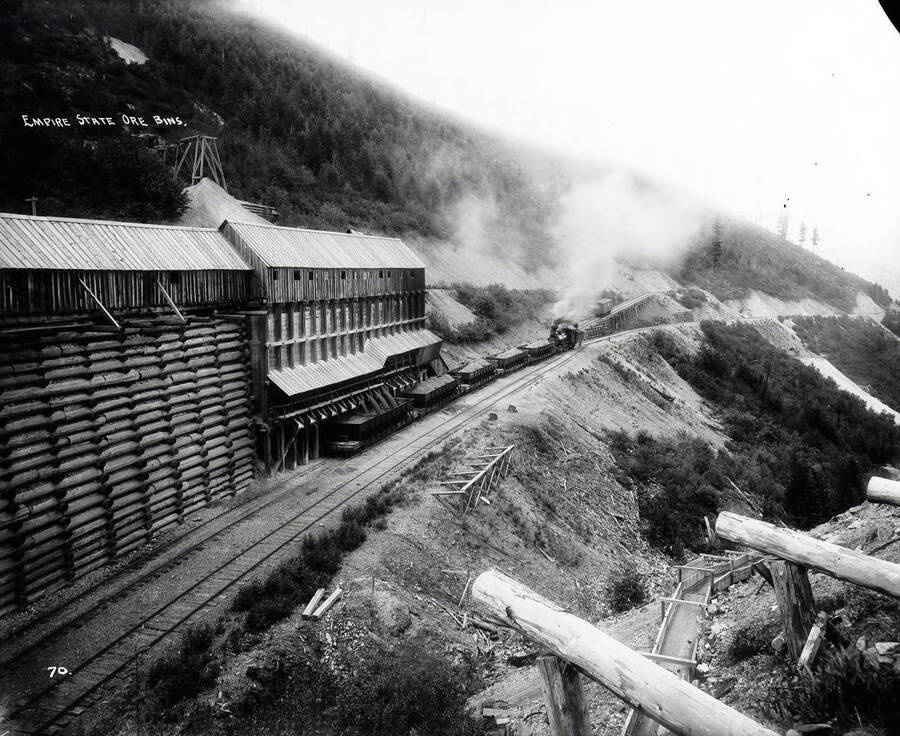 Distant view of the Empire State-Idaho Mining and Developing Co., where railroad cars being loaded with ore, near Wardner, Idaho.