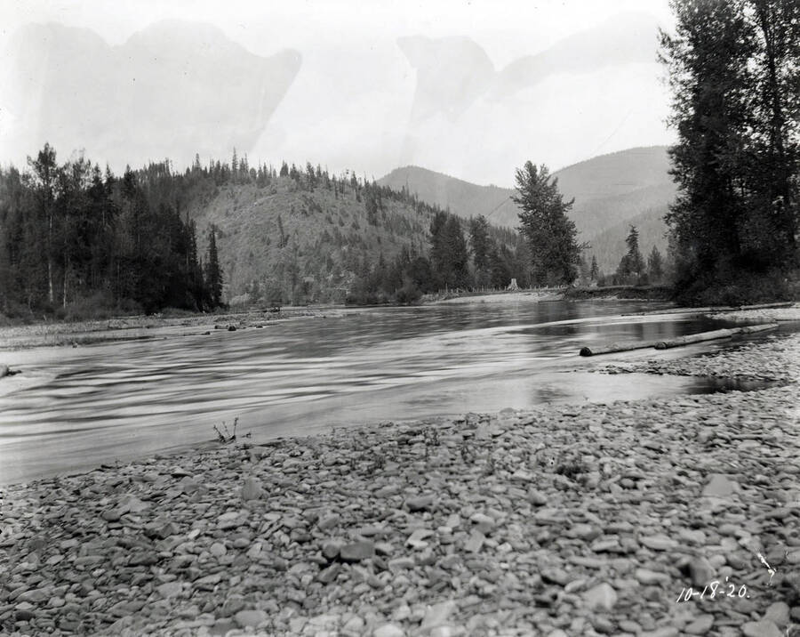 Image shows a river with tree covered hillside in the background. The image was taken at Linfor October 18, 1920 for T. Towles.