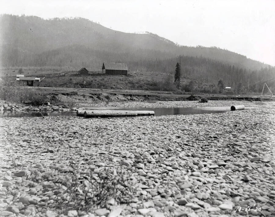 Image shows a river bed with some farming building in the background. The image was taken at Linfor October 18, 1920 for T. Towles.