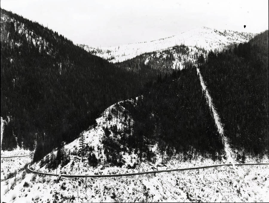 Image shows a flume along a snow covered mountain.