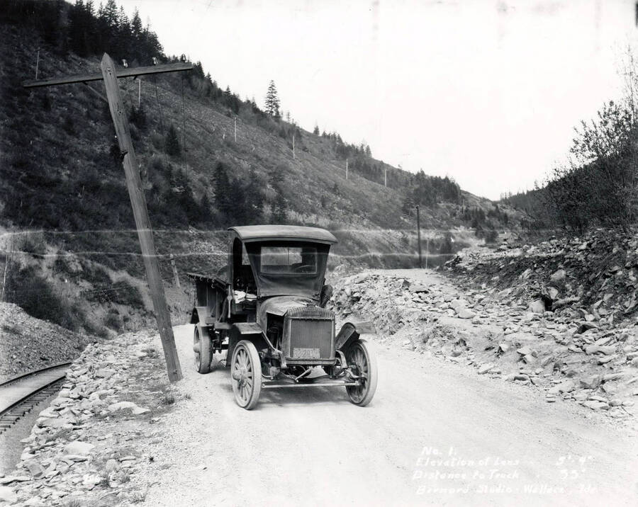 A meat truck on Mullan Road, one of the first major engineered highways in the Pacific Northwest that runs parallel to the current Interstate 90. Images shows a section of Mullan Road in Wallace, Idaho, 1924. H.E. Davis