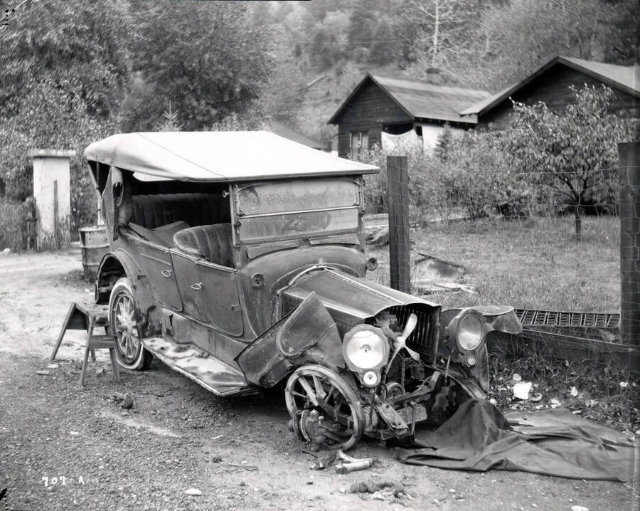 Image shows an automobile in disrepair. Note on back: H.E. Davis,  auto accident
