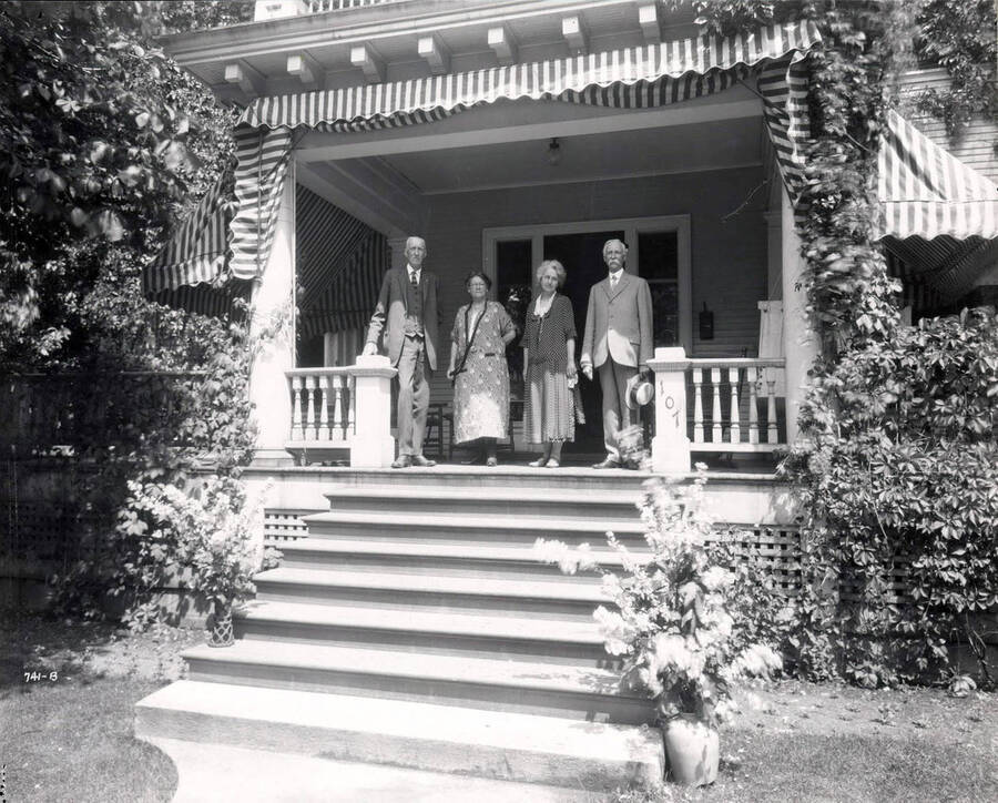 Image shows two women and two men standing on the porch of the C.W. Beale house in Wallace, Idaho, 1925.