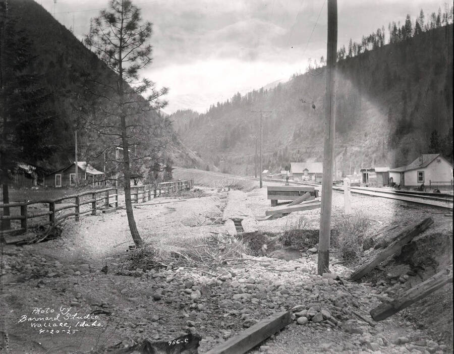 Image shows railroad track and the broken flume on the Lee property in Wallace, Idaho, April 20, 1925.