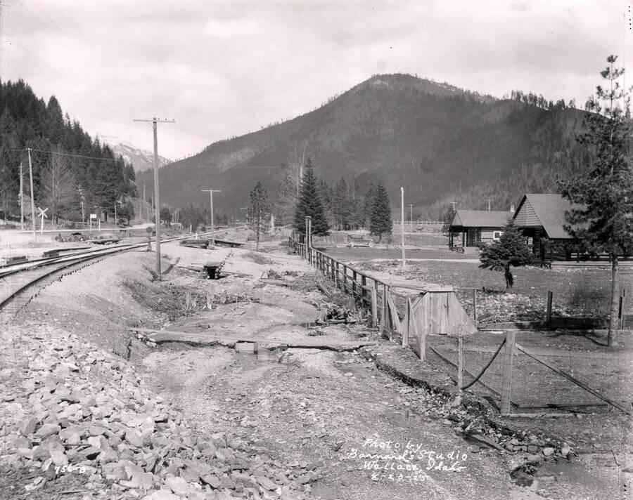 Image shows railroad track and the broken flume on the Lee property in Wallace, Idaho, April 20, 1925.