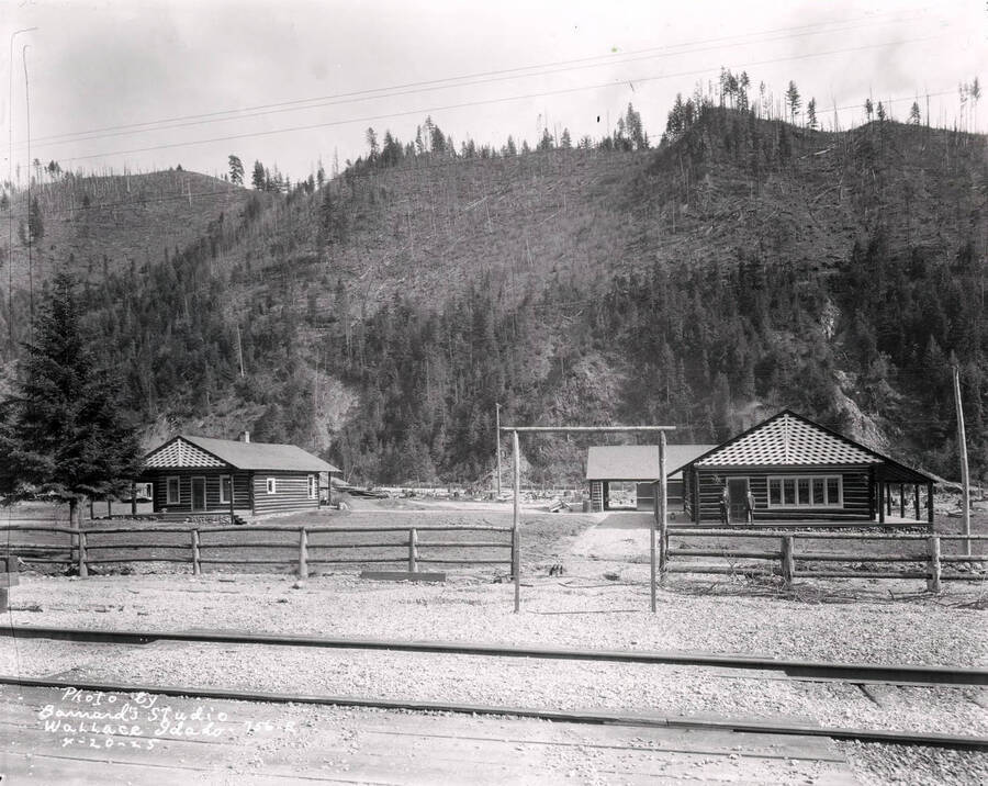 Image shows two men standing in front of a house on the Lee property in Wallace, Idaho, April 20, 1925.